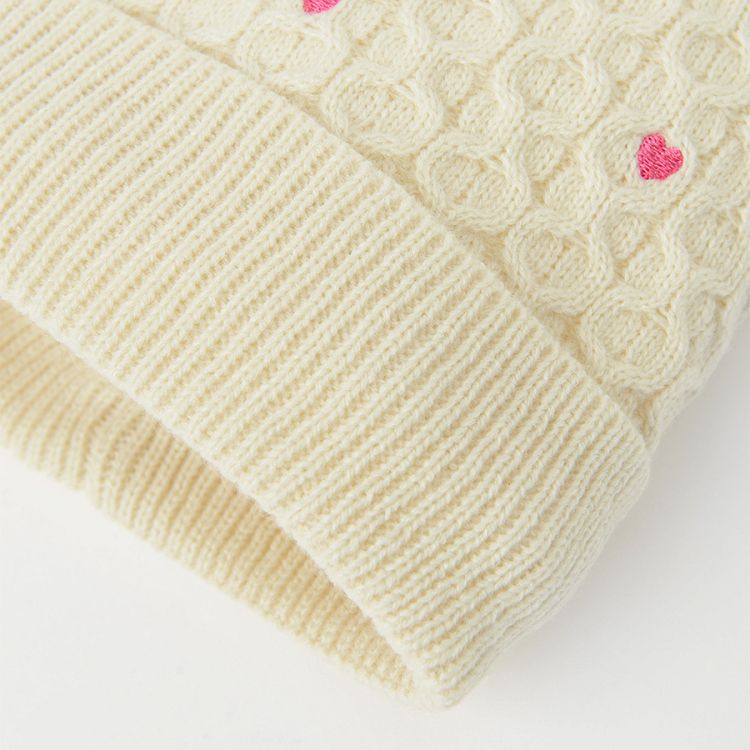 White cap with small hearts and pom pom