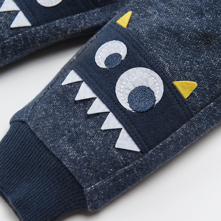 Grey jogging pants with embroidered funny monster faces