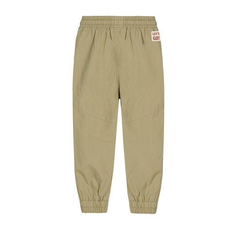 Khaki trousers with cord and elastic band around the ankles