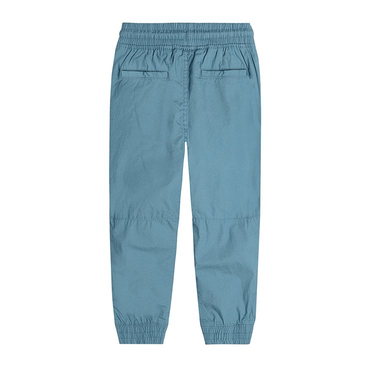Trousers with cord and elastic band around the ankles