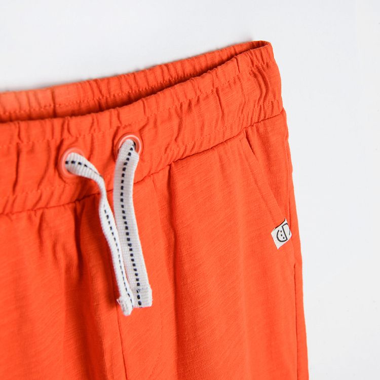 Orange jogging pants with cord
