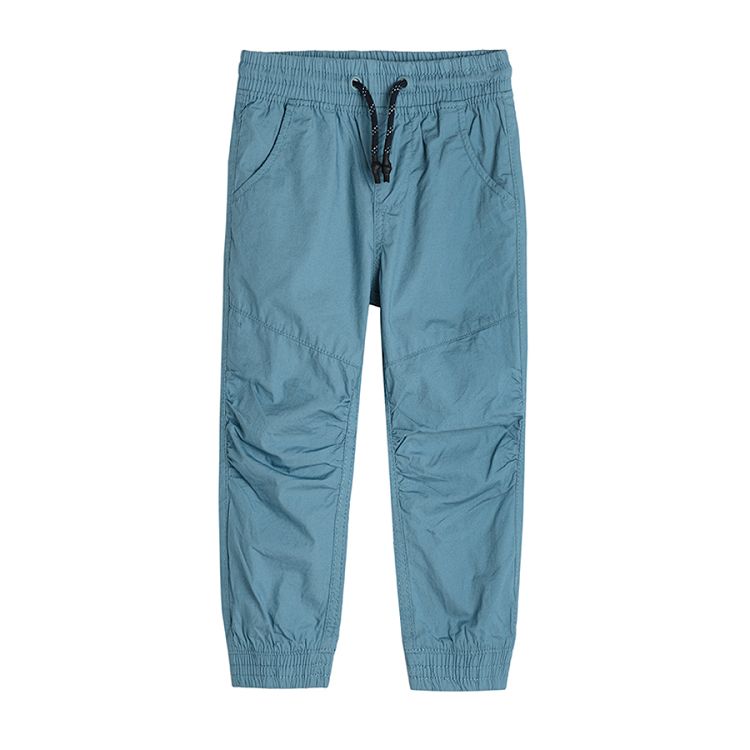 Light blue trousers with elastic waist and elastic band around the ankles