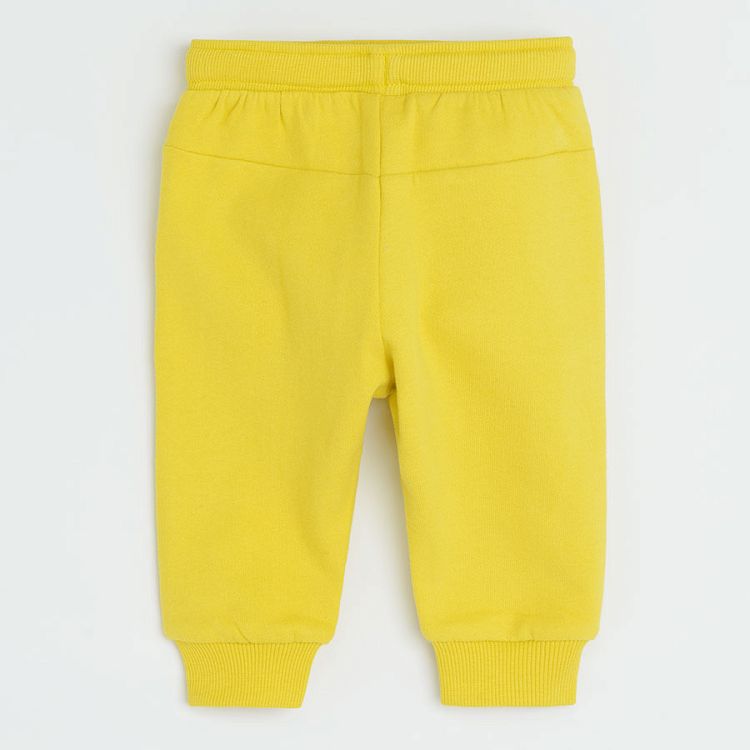Yellow jogging pants with funny face on knee