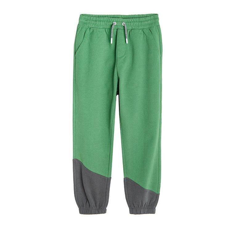 Green jogging pants with cord on the waist and elastic ankle