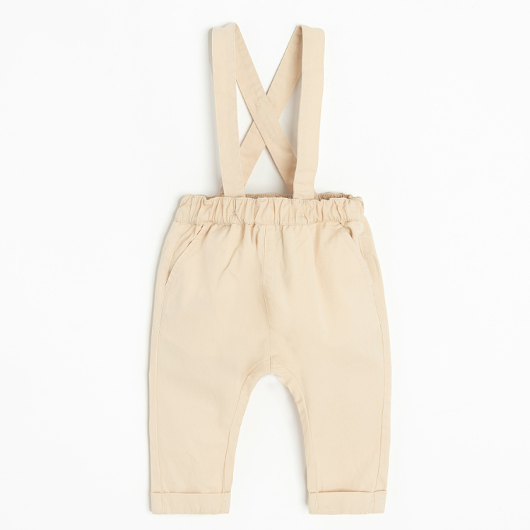 Brown bodysuit with bow tie and ecru pants with suspenders