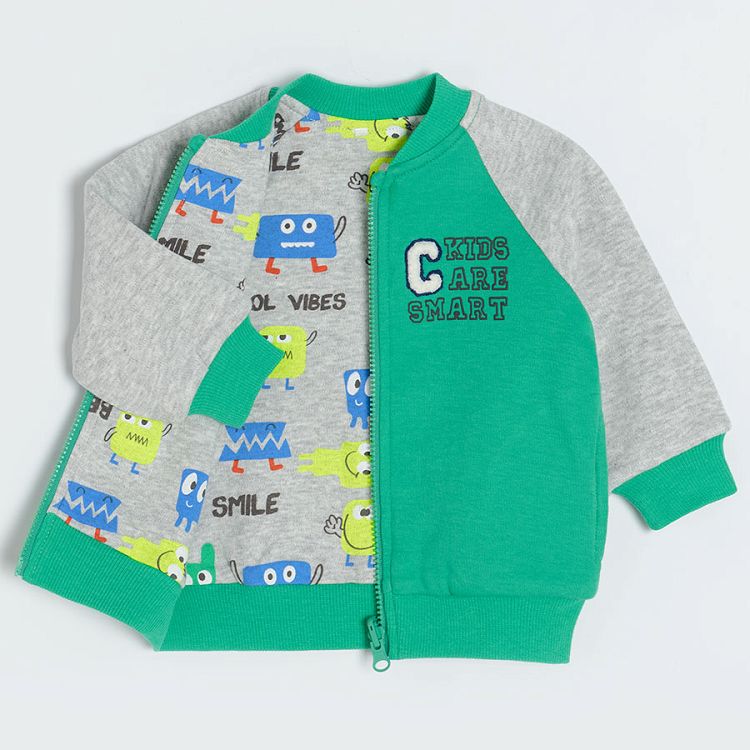 Green zip through hooded sweatshirt with animals print on the inside lining