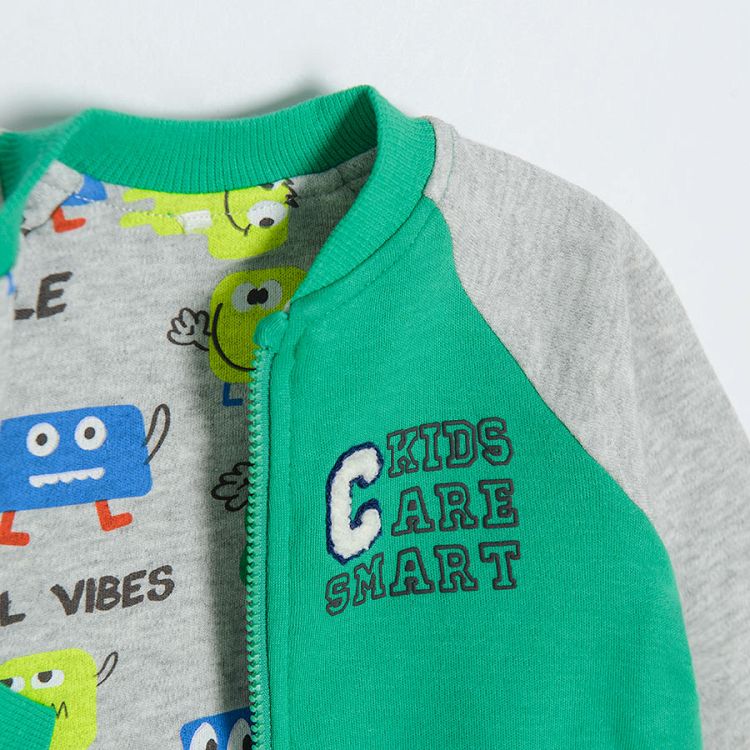 Green zip through hooded sweatshirt with animals print on the inside lining