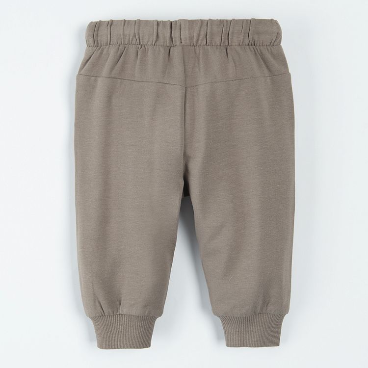 Light borwn jogging pants with lions print on the knees and adjustable waist