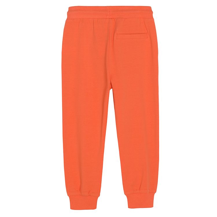 Red jogging pants with adjustable waist and elastic band around the ankles