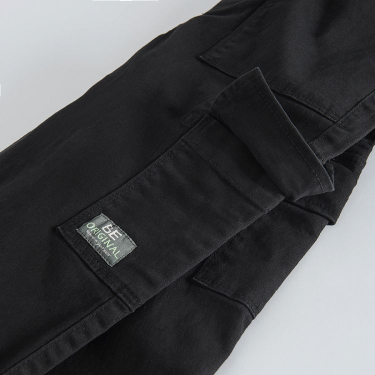 Black trousers with external side pockets and adjustable waist