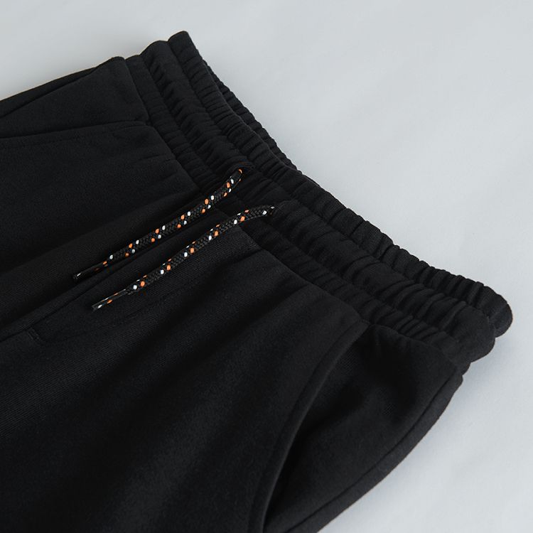 Black jogging pants with print on one knee