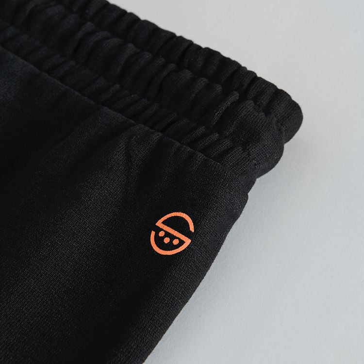 Black jogging pants with print on one knee