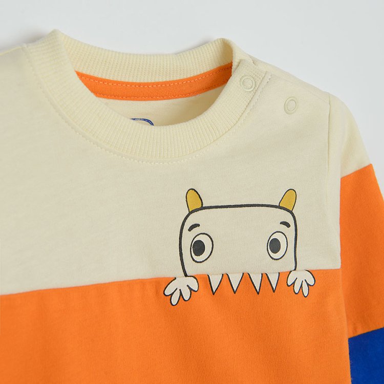 Blue, orange and white long sleeve blouse with dinosaur on skateboard print