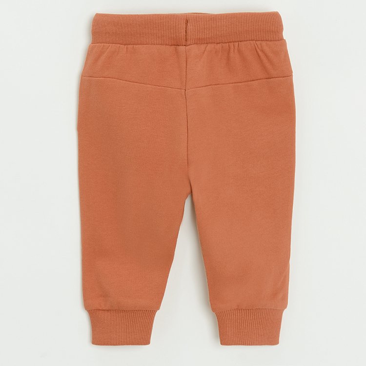 Brown jogging pants with bears print with pom pom caps on the knees