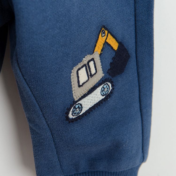 Blue jogging pants with trucks print on the knees