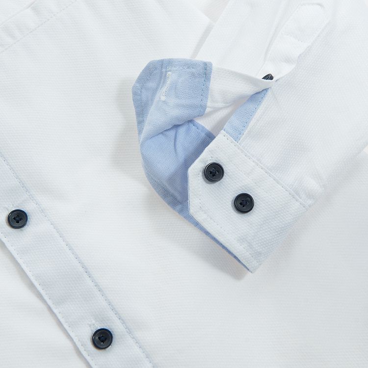 White long sleeve shirt with sleeve rolling up to a button