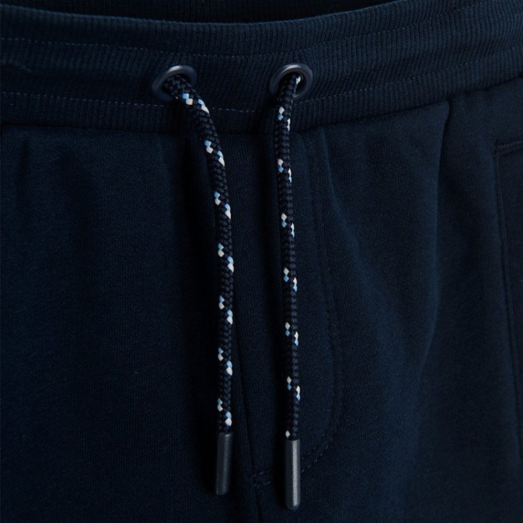 Black jogging pants with light blue, red and white stripe on the side
