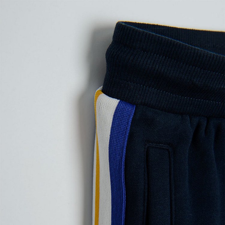 Black jogging pants with light blue, red and white stripe on the side