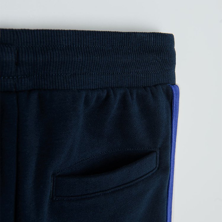 Black jogging pants with light blue, red and white stripe on the side