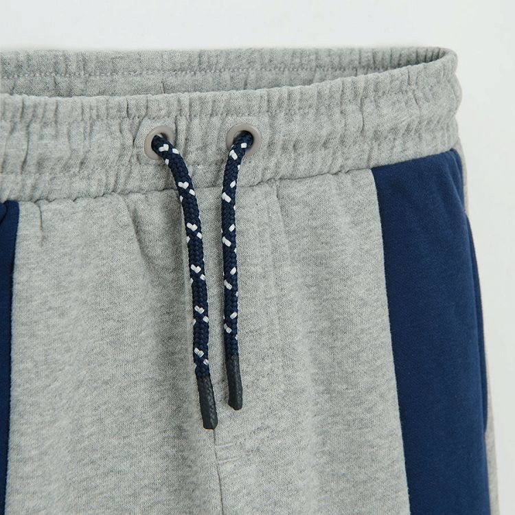 Grey jogging pants with blue and green stripes