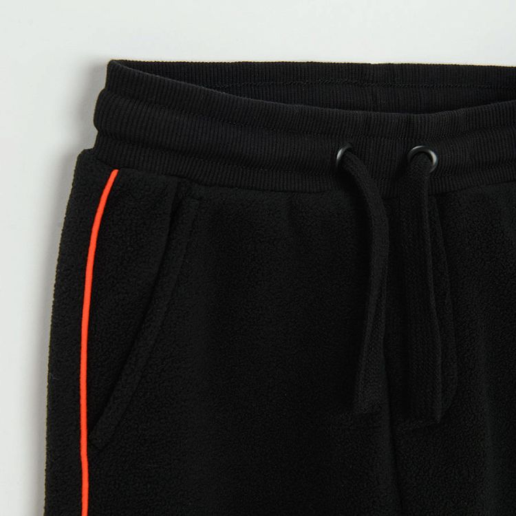 Black jogging pants with orange side stripe