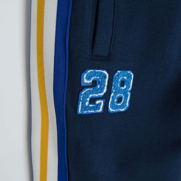 Dark blue jogging pants with yellow, white and blue stripe on the side