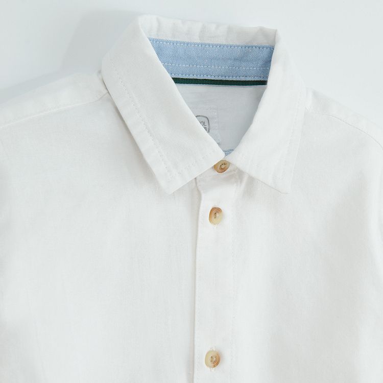 White long sleeve shirt with sleeve rolling up to a button