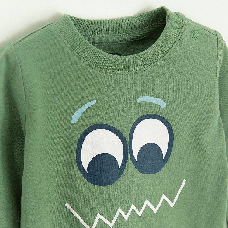 Green long sleeve blouse with funny face print