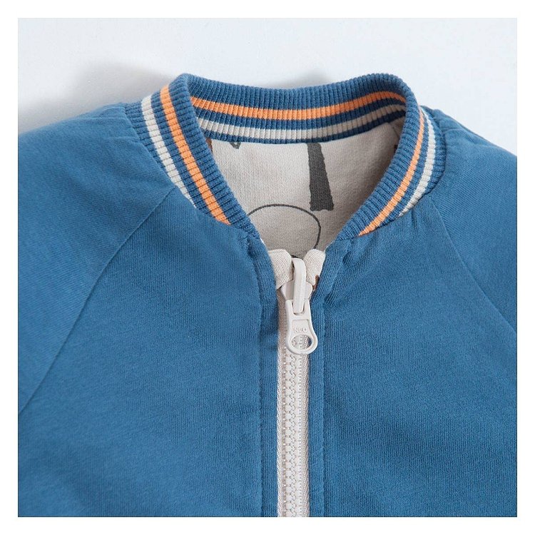 Blue and reversible ecru with dinosaurs print zip through sweatshirt