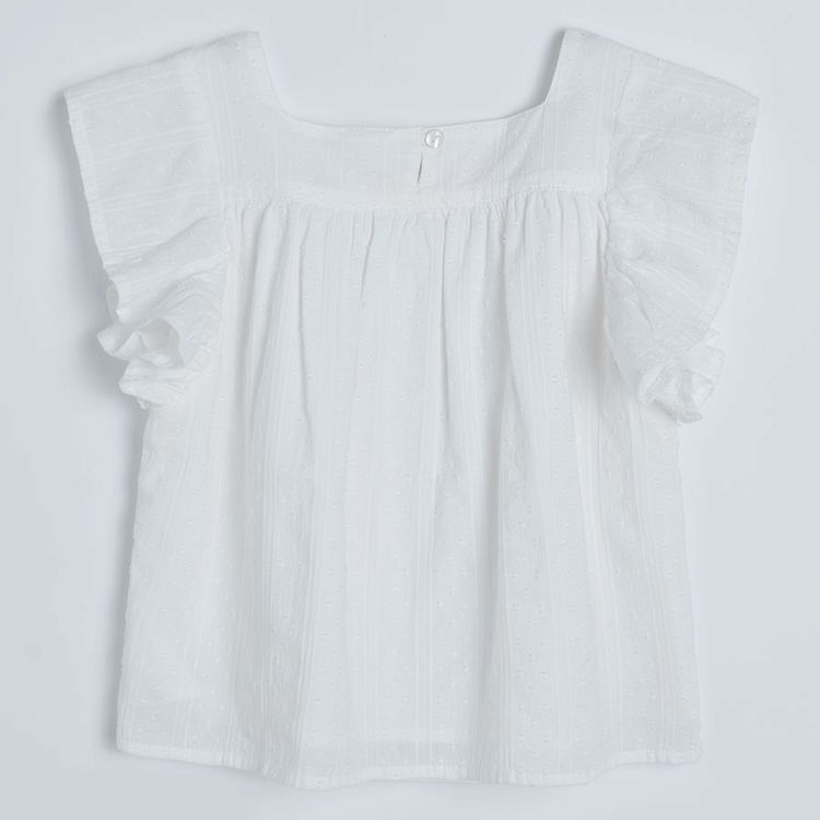 White sleeveless blouse with square embrodered neckline and ruffles on the shoulders
