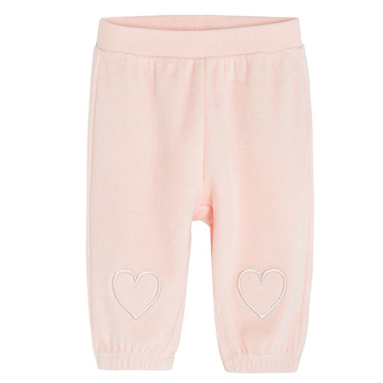 Pink velvet jogging pants with hearts on the ankles