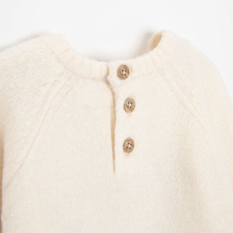White sweater with raindeer print and ruffle at the bottom