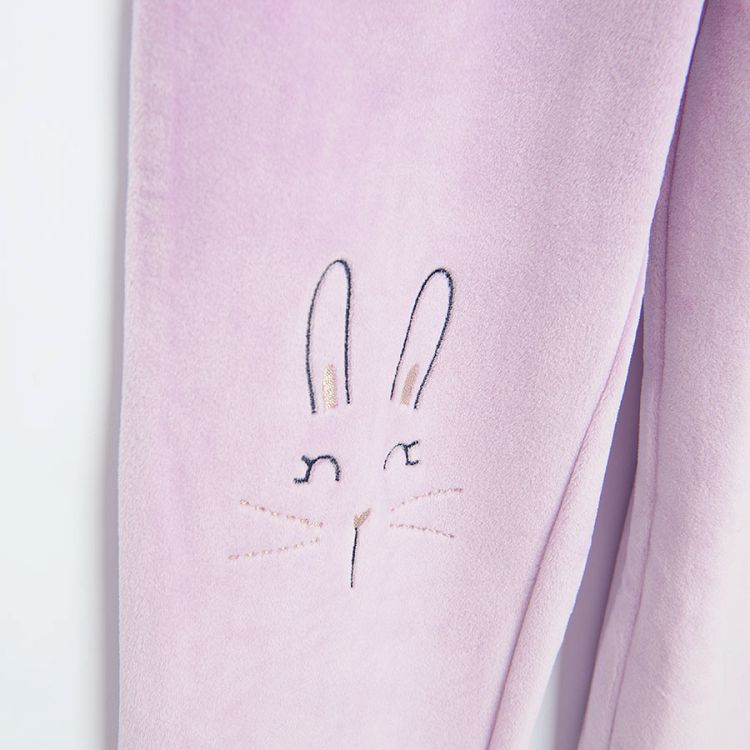Purple jogging pants with bunny faces on the knees