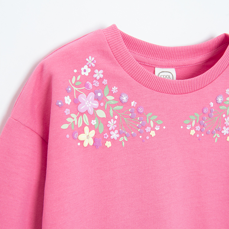 Pink sweatshirt with floral embroidery around the neckline