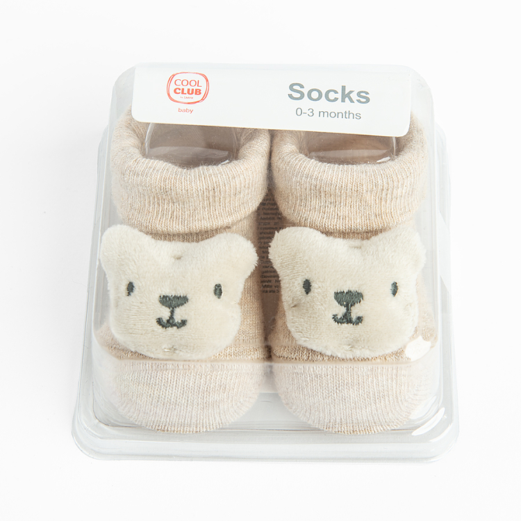 Beige newborn socks with small bear in a box