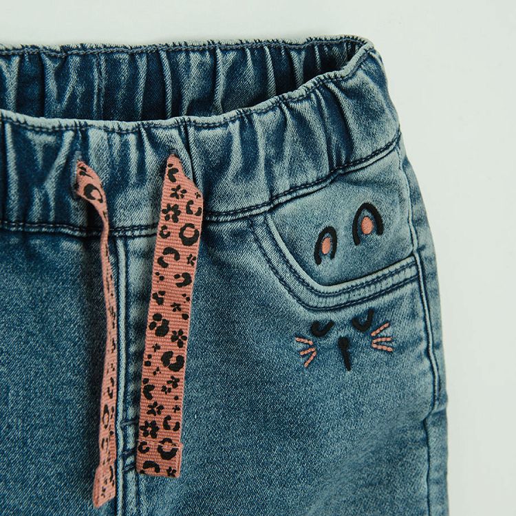 Denim pants with kitten prints on the pockets and pink lining