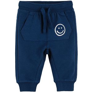 Navy blue jogging pants with pockets on the front and adjustable waist