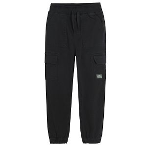 Black trousers with external side pockets and adjustable waist