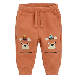Brown jogging pants with bears print with pom pom caps on the knees