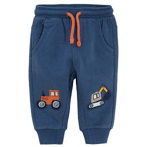 Blue jogging pants with trucks print on the knees
