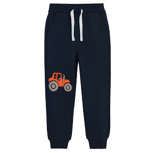 Blue jogging pants with elastic waist and truck print on the knee