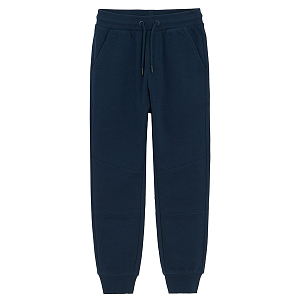 Dark blue sweatpants with elastic around ankles and cord