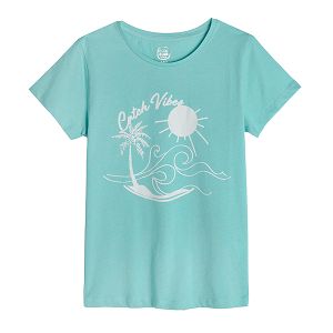 Light blue short sleeve blouse with beach print