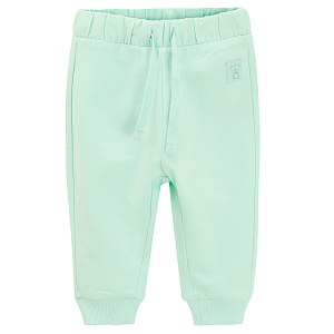 Lint sweatpants with elastic around the ankles and cord