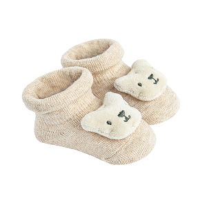 Beige newborn socks with small bear in a box
