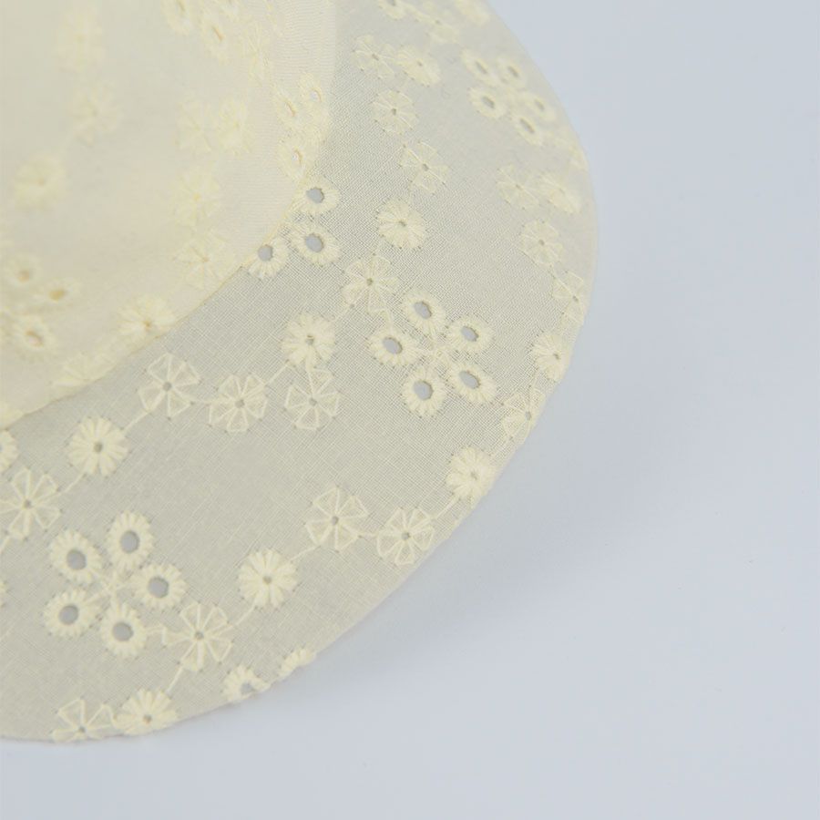 Yellow jockey hcap with flower print and bow on the elastic band