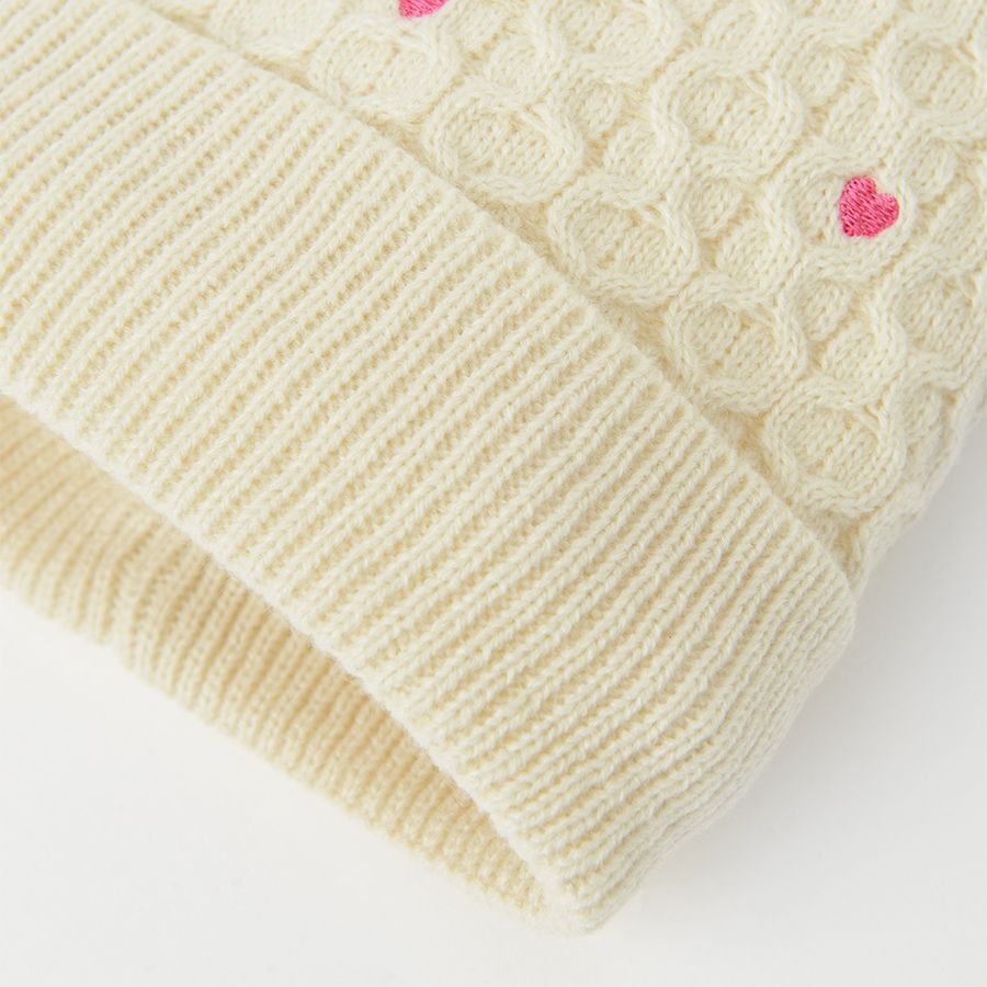 White cap with small hearts and pom pom