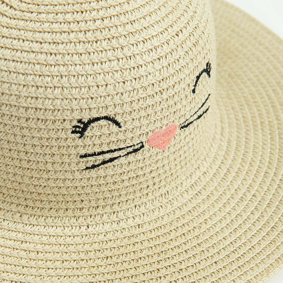 Straw hat with kitten face pattern