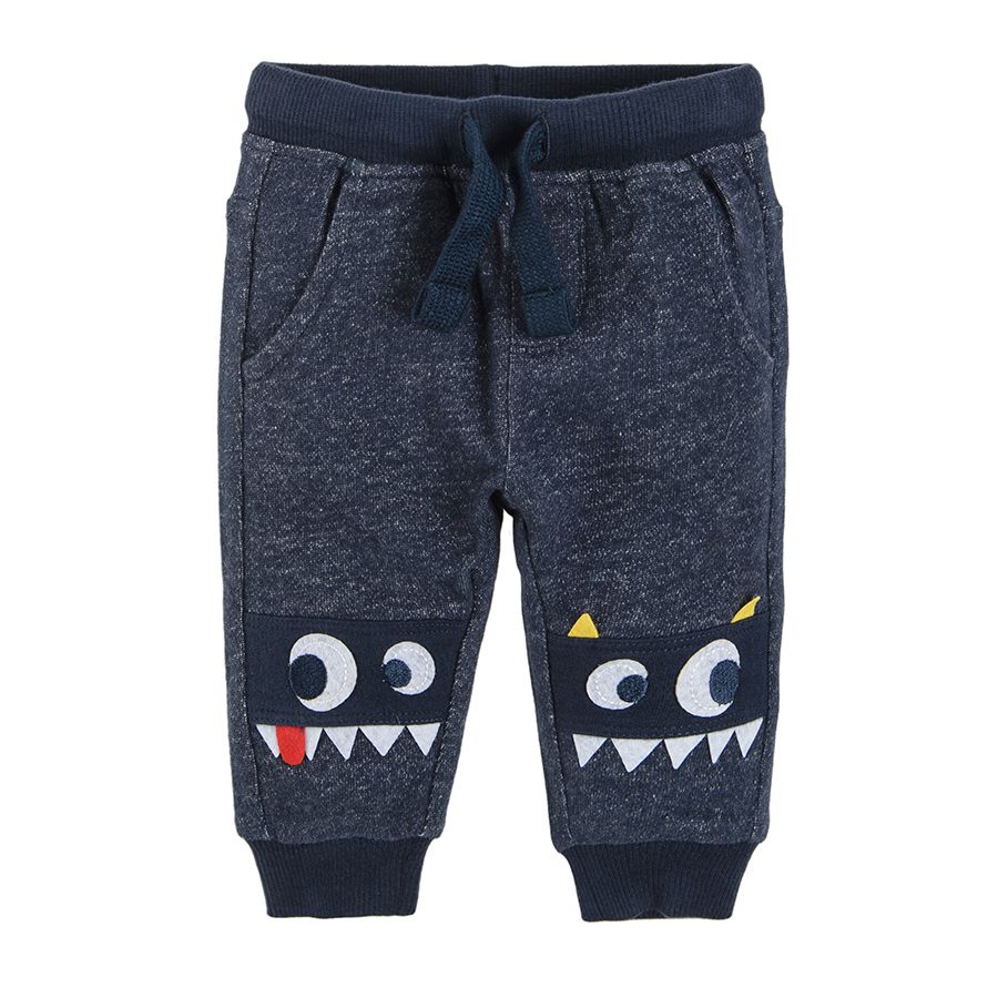 Grey jogging pants with embroidered funny monster faces