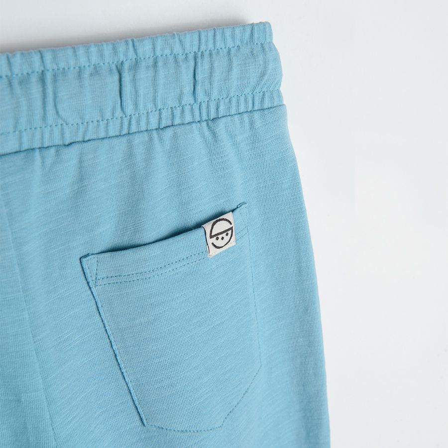 Blue jogging pants with cord and pockets with zipper